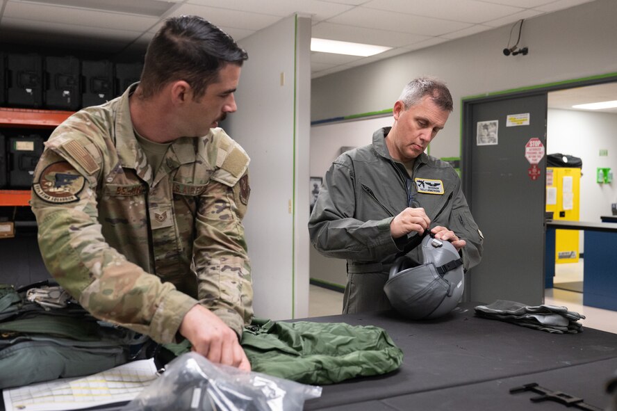 North Dakota Gov. Kelly Armstrong (right) adjusts his flight helmet before an orientation flight at Minot Air Force Base, North Dakota, June 30, 2025. Orientation flights are opportunities to educate key leaders on the 5th Bomb Wing’s mission capabilities. (U.S. Air Force photo by Senior Airman Kendra A. Ransum)