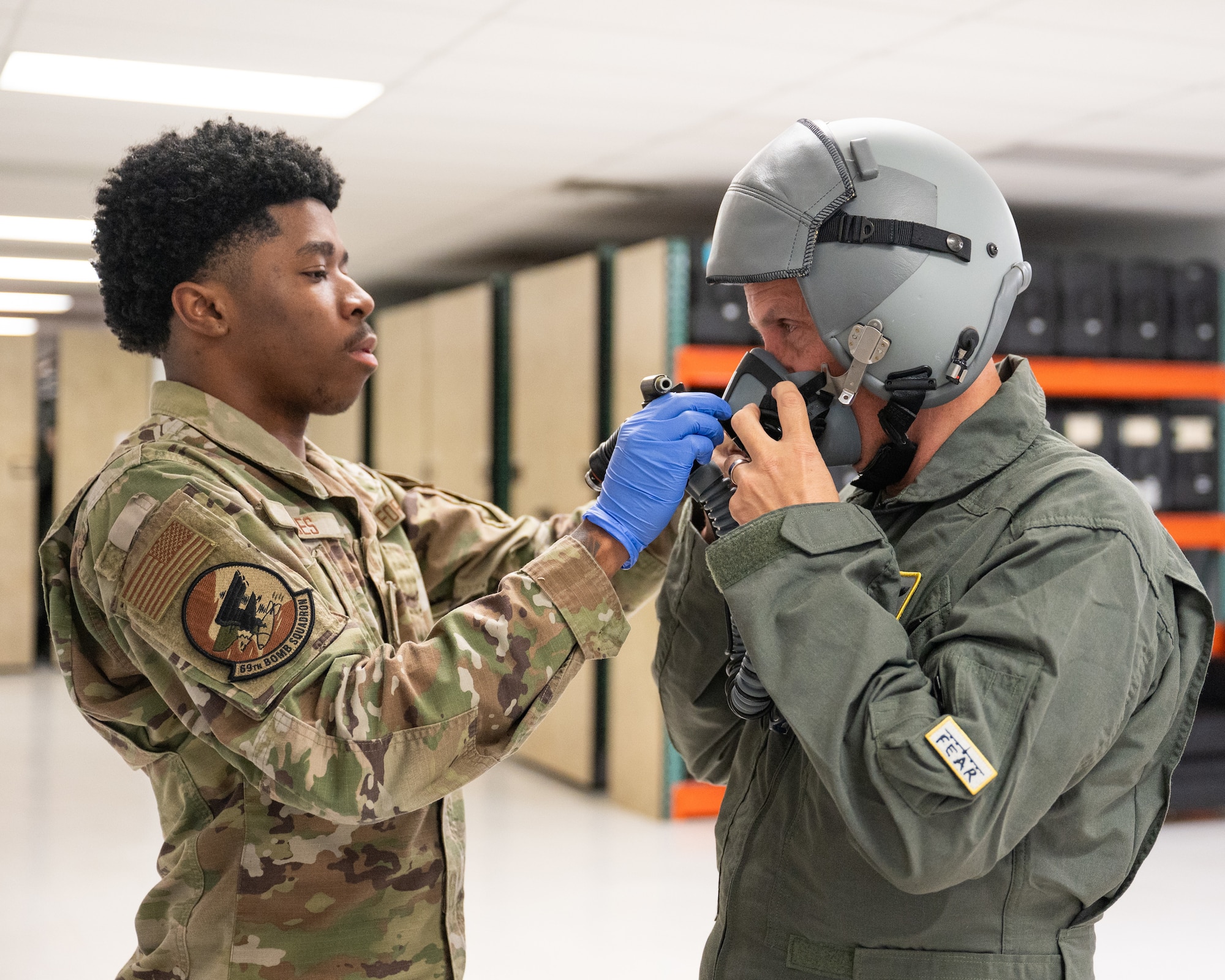 North Dakota Gov. Kelly Armstrong (right) receives assistance with his fitting his oxygen mask from Airman 1st Class Jahleel Wages, 69th Bomb Squadron aircrew flight equipment technician, at Minot Air Force Base, North Dakota, June 30, 2025. The governor was greeted by base leadership, received flight safety training and flew with 69BS aircrew on B-52H Stratofortress over Bismarck, North Dakota. (U.S. Air Force photo by Senior Airman Kendra A. Ransum)