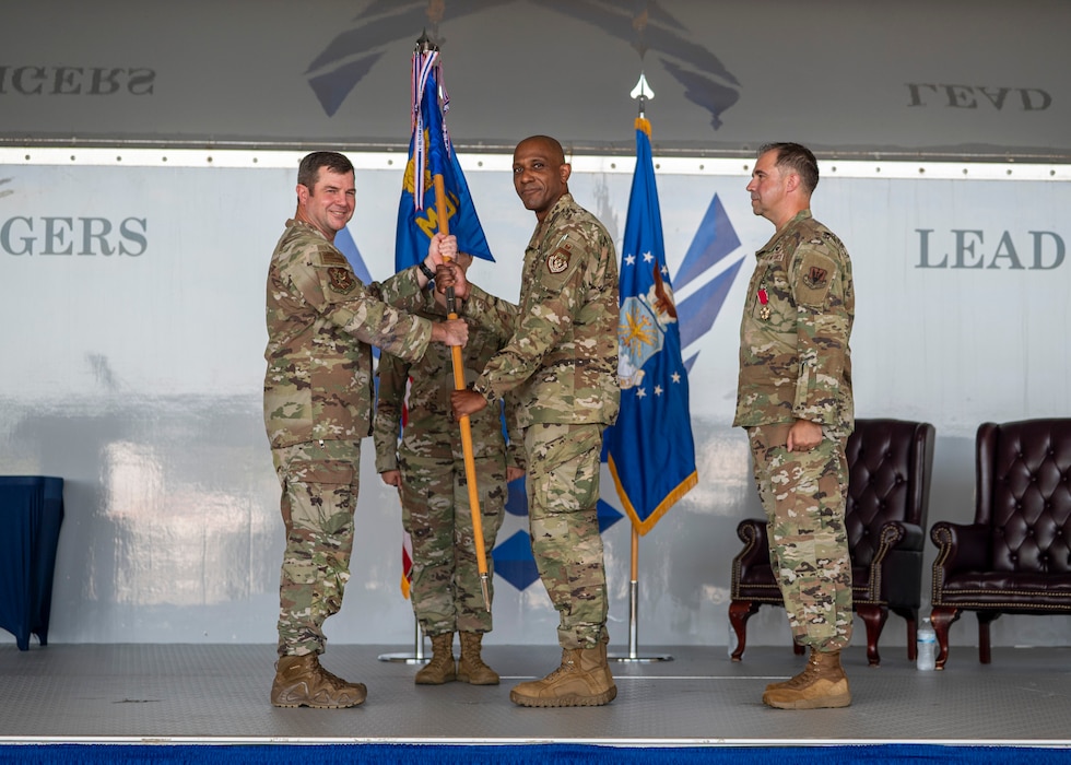 U.S. Air Force Col. Mark Dudley assumes command of the 23rd Medical Group as he receives the guidon from Col. Paul Sheets, 23rd Wing commander, during a change of command ceremony at Moody Air Force Base, Georgia, July 11, 2025. As a proud tradition, the guidon pass marks the moment a new leader assumes responsibility and authority from their predecessor. (U.S. Air Force photo by Senior Airman Leonid Soubbotine)