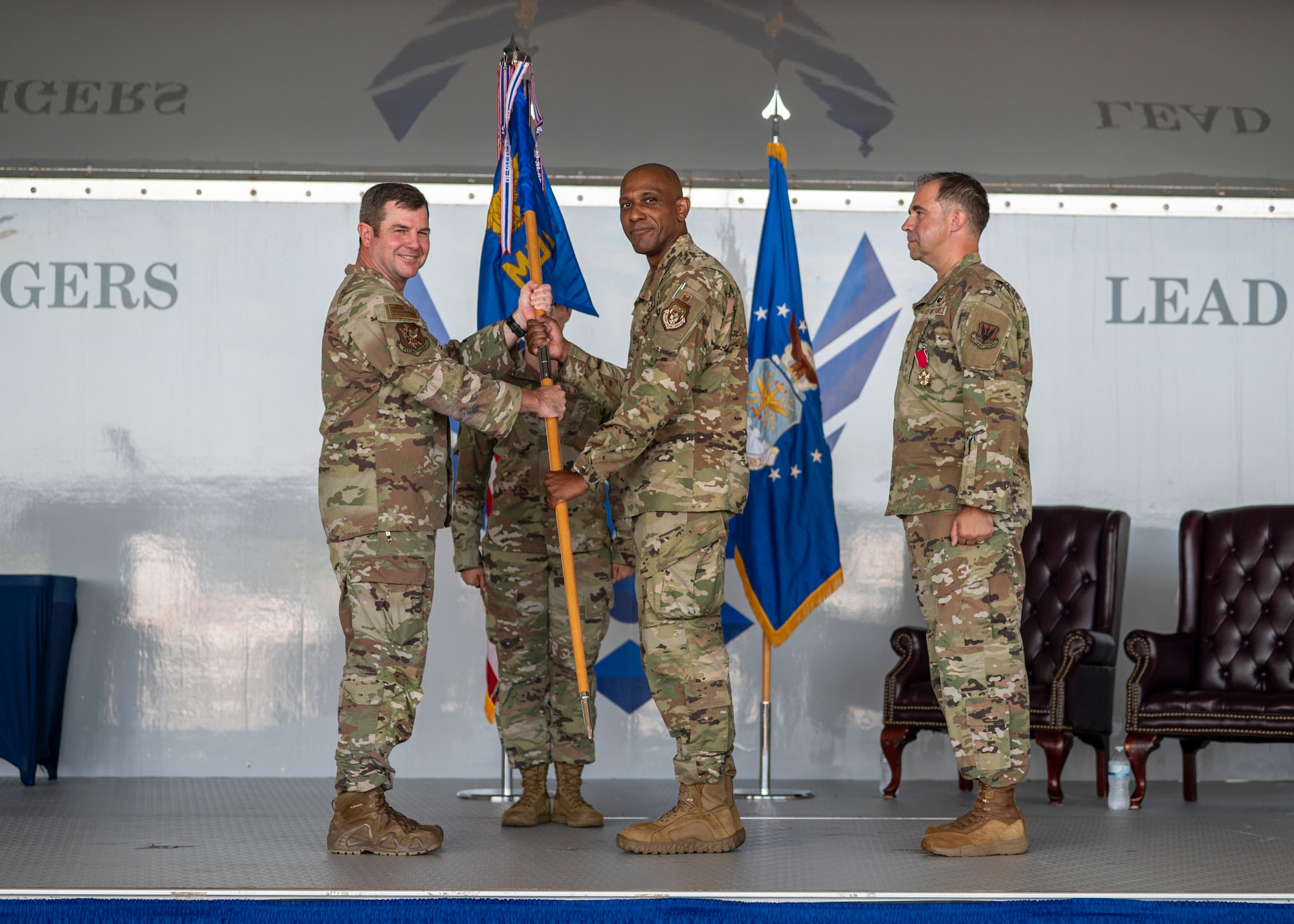 U.S. Air Force Col. Mark Dudley assumes command of the 23rd Medical Group as he receives the guidon from Col. Paul Sheets, 23rd Wing commander, during a change of command ceremony at Moody Air Force Base, Georgia, July 11, 2025. As a proud tradition, the guidon pass marks the moment a new leader assumes responsibility and authority from their predecessor. (U.S. Air Force photo by Senior Airman Leonid Soubbotine)