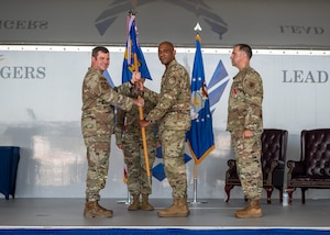 U.S. Air Force Col. Mark Dudley assumes command of the 23rd Medical Group as he receives the guidon from Col. Paul Sheets, 23rd Wing commander, during a change of command ceremony at Moody Air Force Base, Georgia, July 11, 2025. As a proud tradition, the guidon pass marks the moment a new leader assumes responsibility and authority from their predecessor. (U.S. Air Force photo by Senior Airman Leonid Soubbotine)