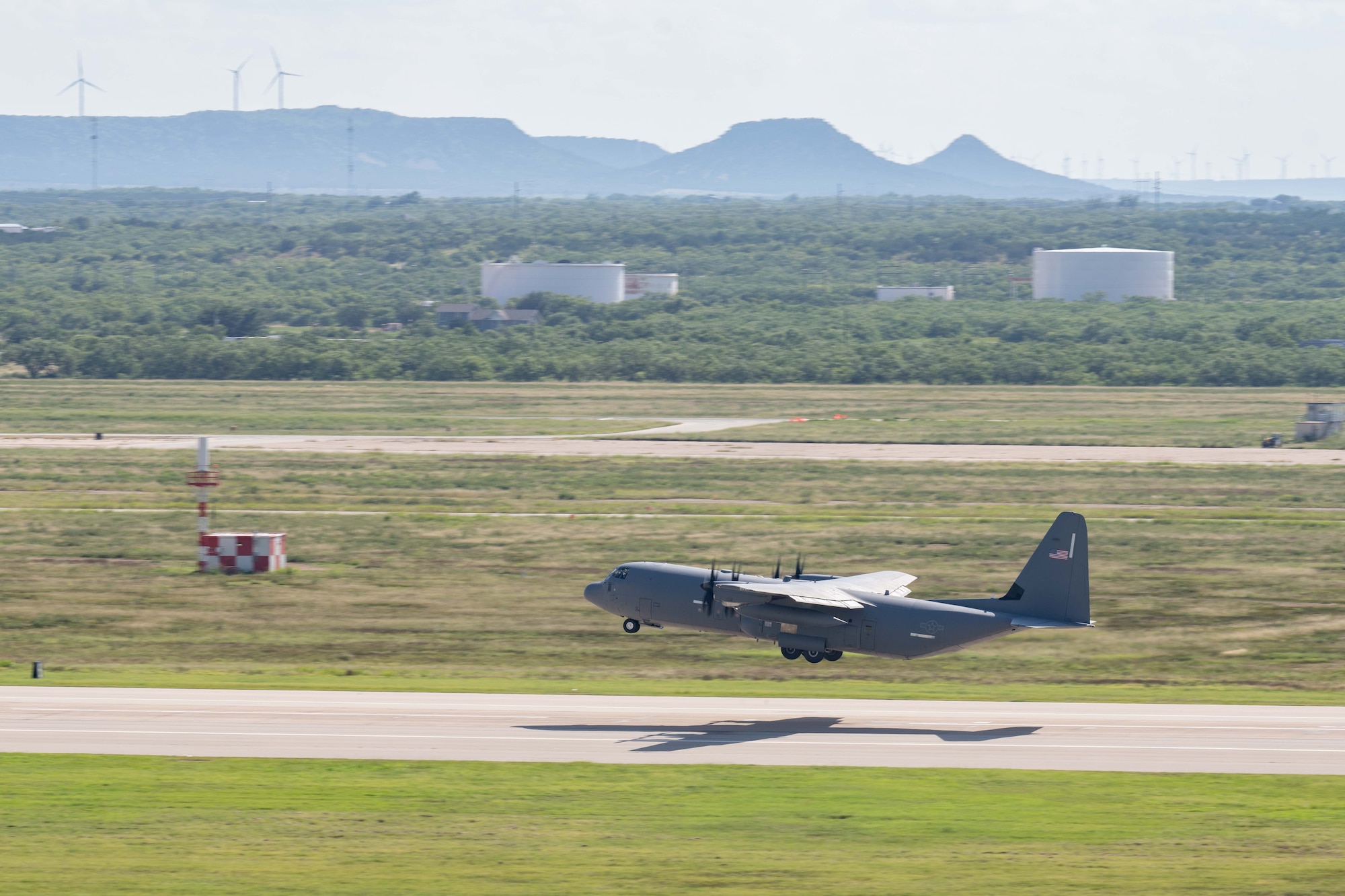 A U.S. Air Force C-130J Super Hercules assigned to the 39th Airlift Squadron takes off the runway during a Max Endurance Operation in support of the 2025 Department-Level Exercise series at Dyess Air Force Base, Texas, July 8, 2025. Air Mobility Command’s rapid deployment into theater provides the global mobility required to enable the U.S. Air Force’s execution of the DLE series at speed and scale. The DLE series encompasses all branches of the Department of Defense, along with Allies and partners, employing more than 400 Joint and coalition aircraft and more than 12,000 members at more than 50 locations across 3,000 miles. (U.S. Air Force photo by Airman Caleb Schellenberg)