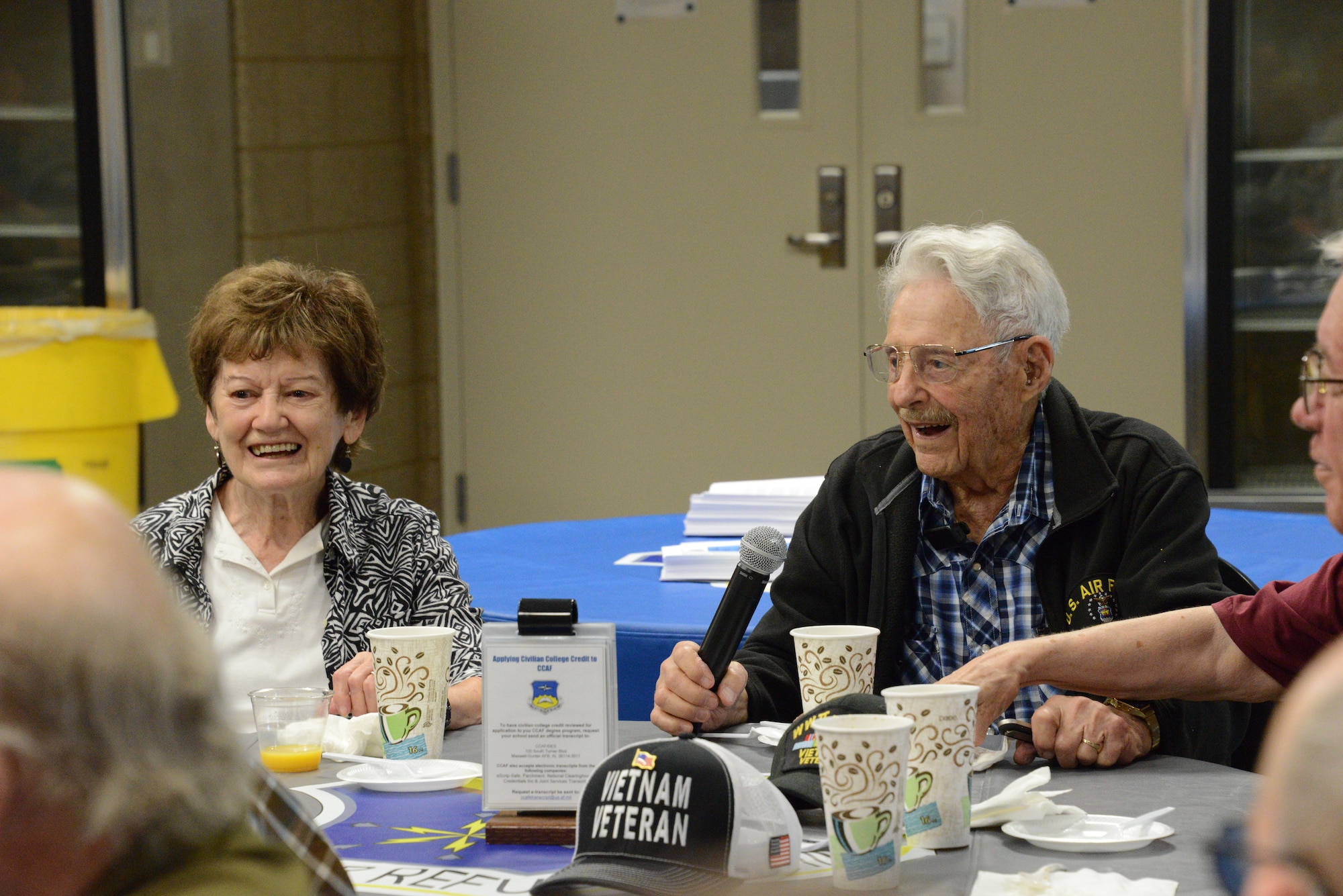 Robert Irwin sits at a table with microphone in hand as he speaks