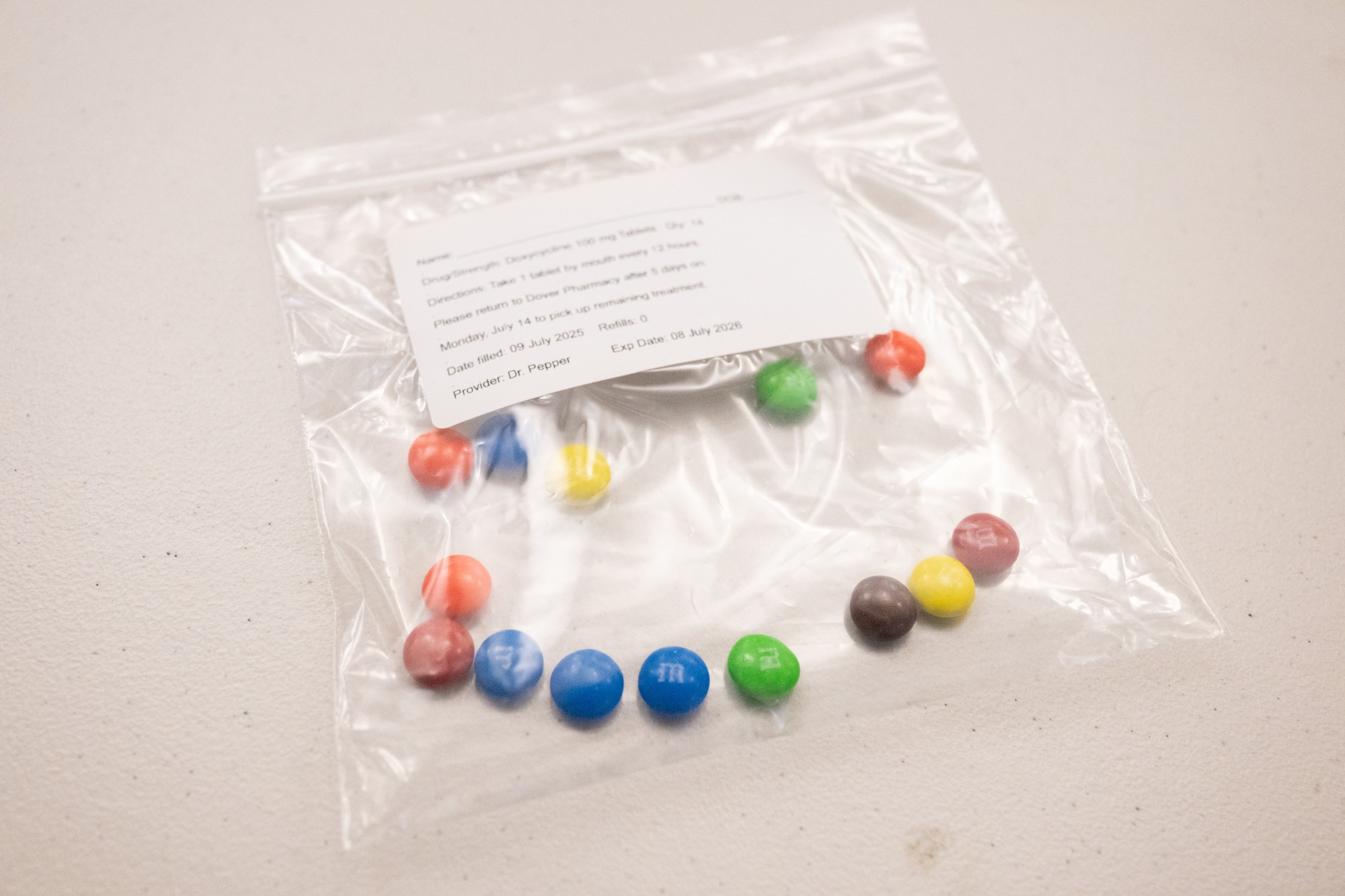 A bag of candy simulating Anthrax medication sits on a table during a biohazard disaster response exercise conducted by the 436th Medical Group at Dover Air Force Base, Delaware, June 9, 2025. The exercise challenged the medical staff personnel on how to triage and treat personnel after being exposed to simulated Anthrax. (U.S. Air Force photo by Mauricio Campino)