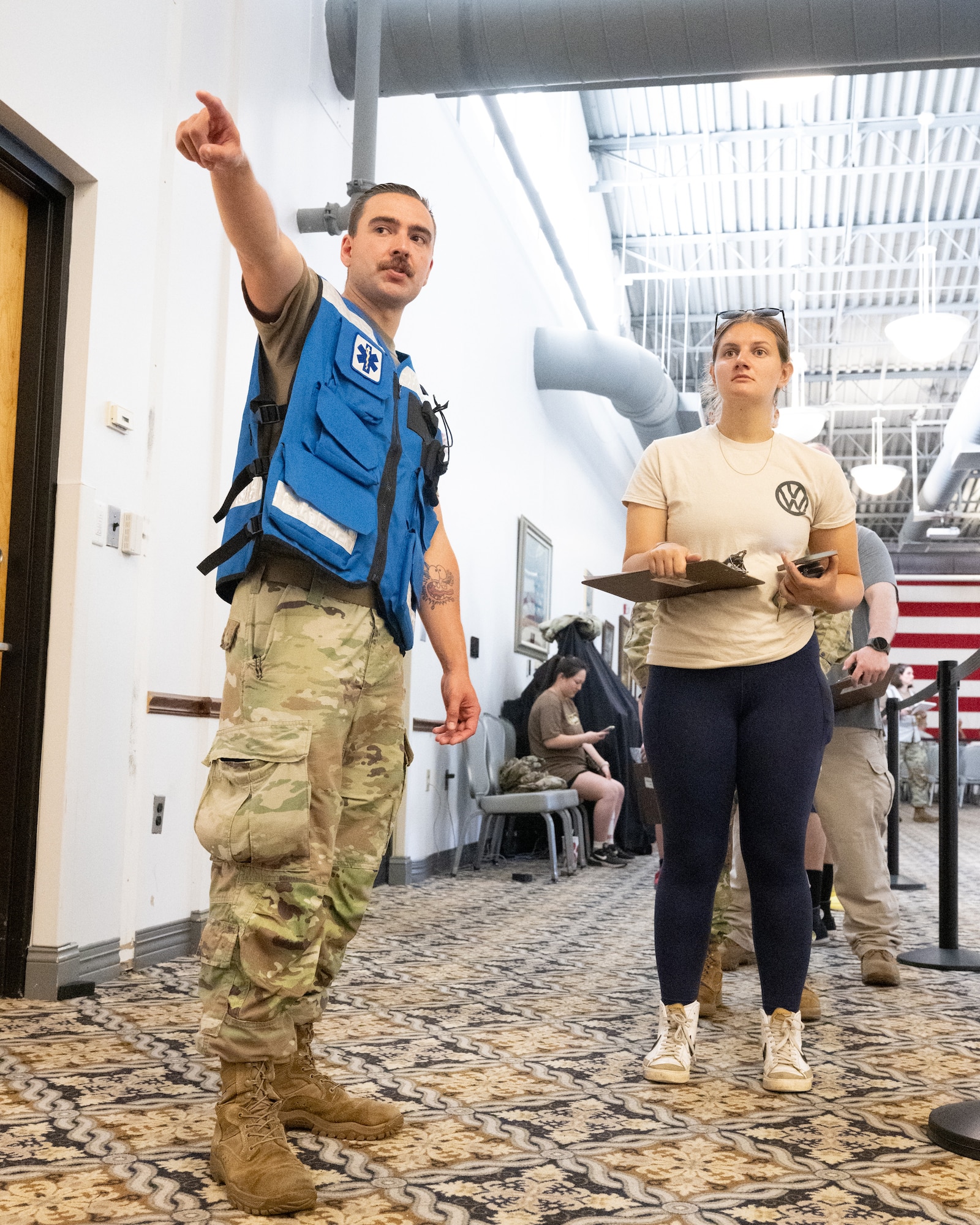U.S. Air Force Tech. Sgt. Andrew Linton, 436th Operational Medical Readiness Squadron human performance flight chief, directs patients during a biohazard disaster response exercise conducted by the 436th Medical Group at Dover Air Force Base, Delaware, June 9, 2025. The exercise challenged the medical staff personnel on how to triage and treat individuals after being exposed to simulated Anthrax. (U.S. Air Force photo by Mauricio Campino)