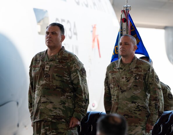 Two U.S. Air Force Colonels stand at attention during the assumption of command.