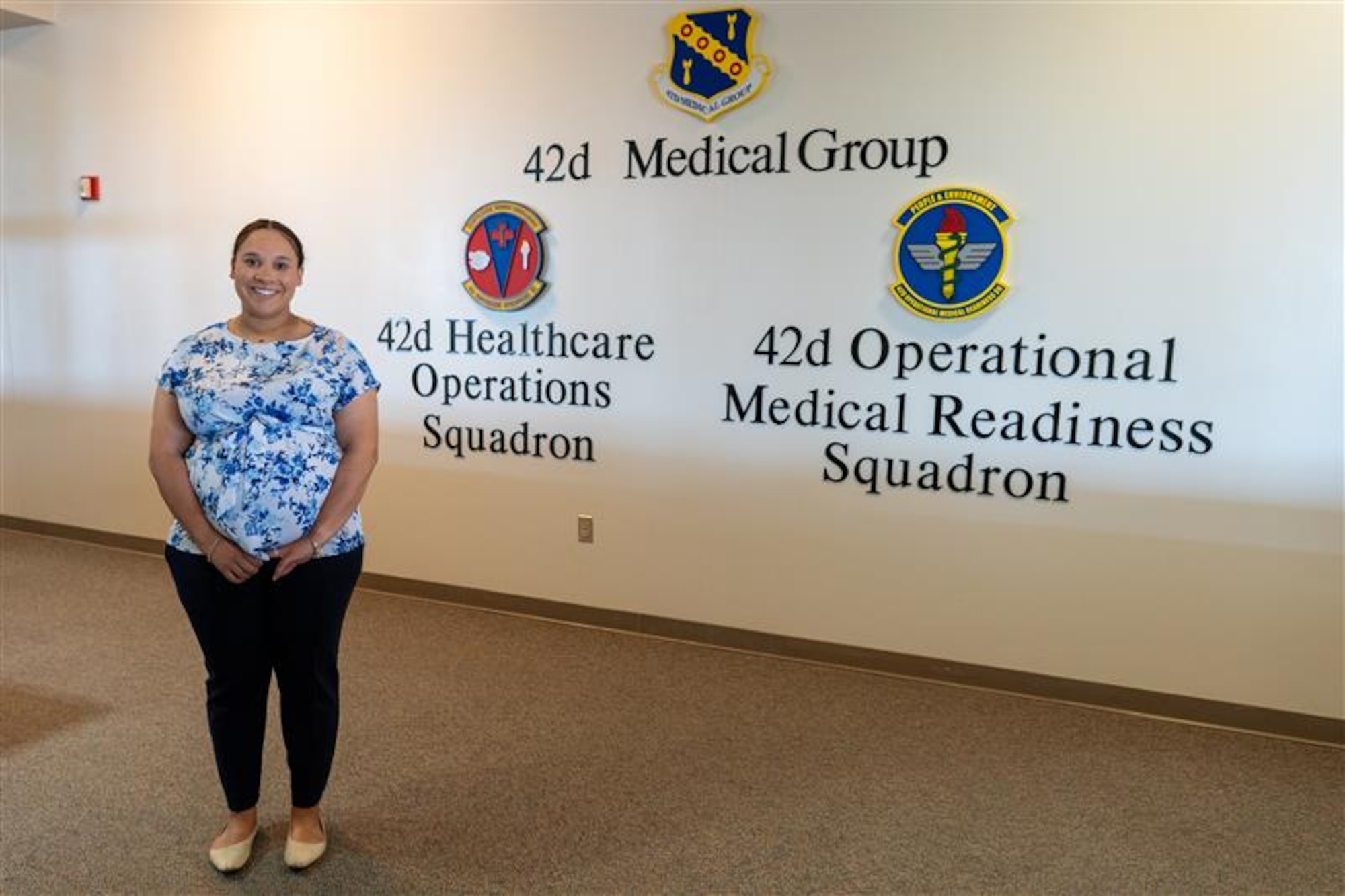U.S. Air Force civilian employee Mrs. Emily Hightower poses for a picture at the 42nd Medical Group building at Maxwell Air Force Base, Alabama, July 2, 2025. Hightower, who serves as the director for patient’s access to care, was recognized as the 42nd Air Base Wing’s Crusader of the Month for June, 2025. (U.S. Air Force photo by Senior Airman Evan Porter)