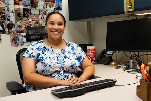 U.S. Air Force civilian employee Mrs. Emily Hightower poses for a picture in her office at the 42nd Medical Group building at Maxwell Air Force Base, Alabama, July 2, 2025. Hightower also serves as a U.S. Air Force Reserve captain with the 908th Aeromedical Staging Squadron. (U.S. Air Force photo by Senior Airman Evan Porter)