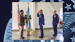 Person accepts command during ceremony.