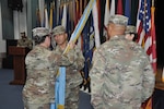 Person passes colors during change of command ceremony.