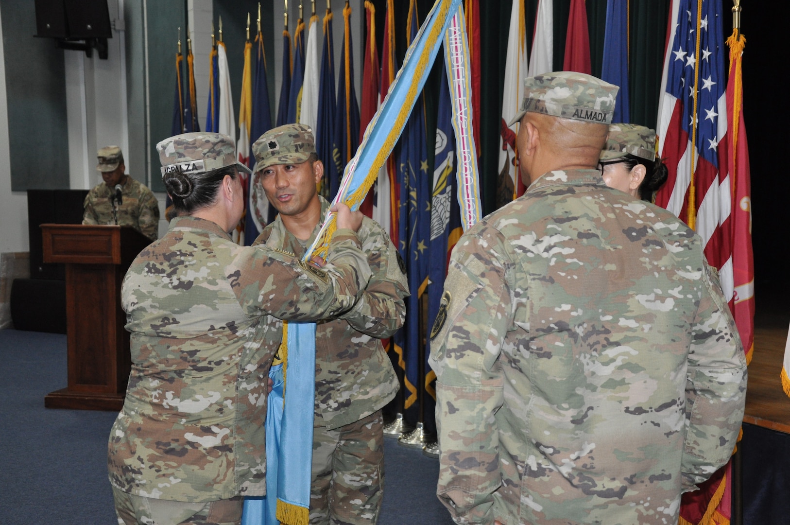 Person passes colors during change of command ceremony.