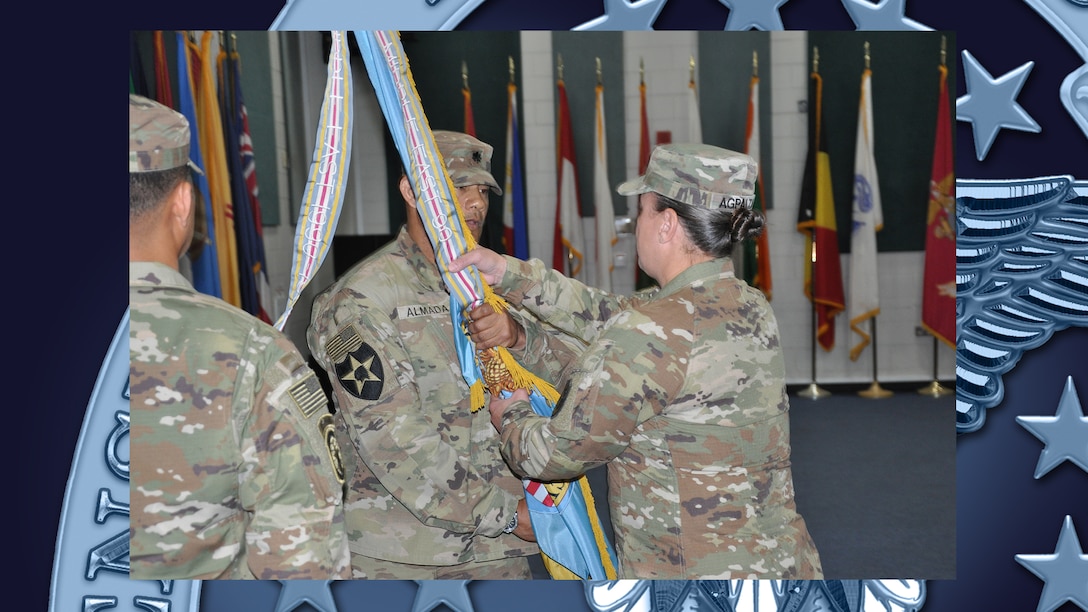 Person receives colors during change of command ceremony.