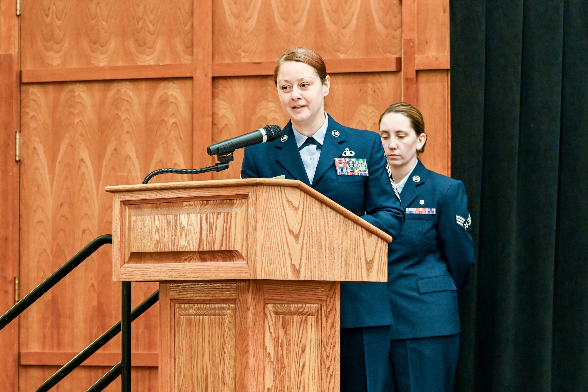 Chief Master Sgt. Gilson delivers remarks from behind a podium.