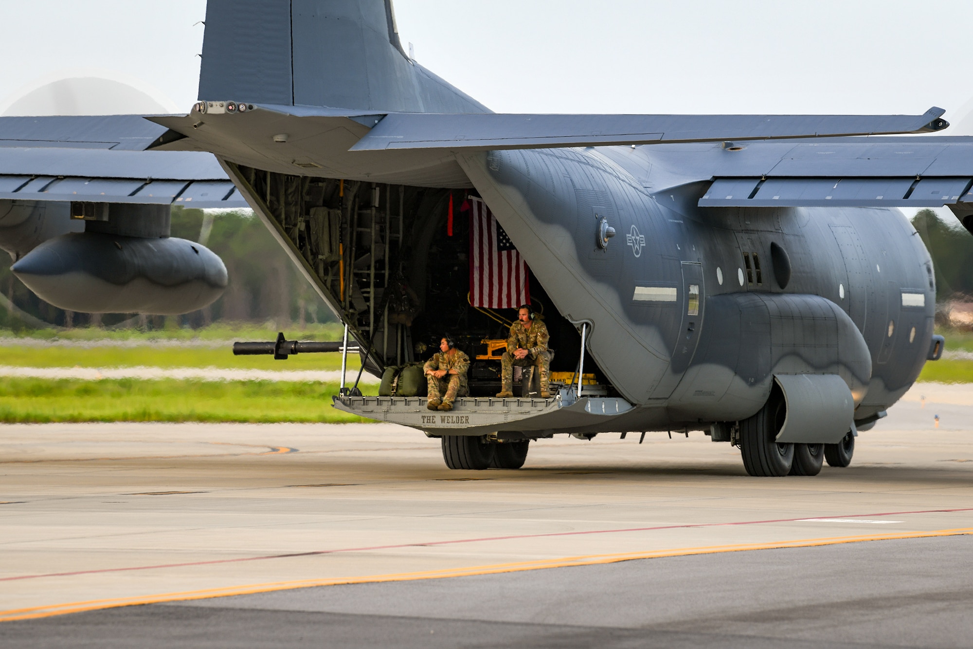 Special Mission Aviators assigned to the 919th Special Operations Wing sit on the ramp of an AC-130J Ghostrider gunship as it taxis towards the runway at Hurlburt Field, Florida, July 9, 2025. The wing’s mission is evolving and now includes an operational AC-130J squadron based at Hurlburt Field, marked by a ceremony held July 11, 2025. The AC-130J is modified a precision strike package, which includes a mission management console, robust communications suite, two electro-optical/infrared sensors, advanced fire control equipment, precision guided munitions delivery capability, as well as trainable 30mm and 105mm weapons. (U.S. Air Force photo by Lt. Col. James Wilson)