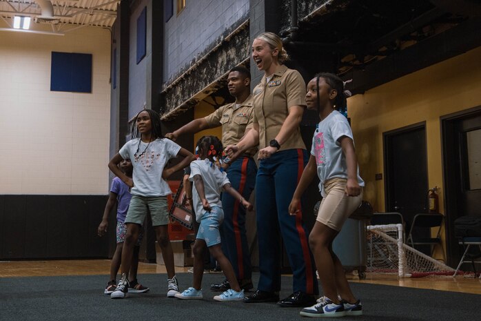 U.S. Marine Corps Staff Sgt. Gustavo Felix, right, a drill instructor with Charlie Company, 1st Recruit Training Battalion, Marine Corps Recruit Depot San Diego, speaks to members of the Marillac Saint Vincent during Marine Week Chicago, Illinois, July 10, 2025. During Marine Week Chicago, Marines with Marine Corps Recruiting Command shared Marine Corps traditions with local high schools in honor of the Corps’ 250th birthday. The Marine Corps is celebrating its 250th birthday with six multi-day Marine Corps community events, called Marine Weeks, in six major cities across the country. Marine Weeks will include activities across each host city featuring aircraft, equipment, recruiting opportunities, and public engagements. (U.S. Marine Corps photo by Cpl. Sarah Grawcock)