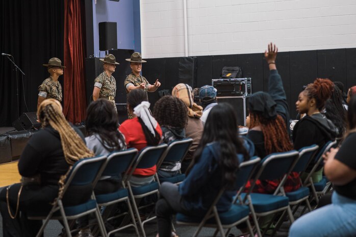 U.S. Marine Corps Staff Sgt. Gustavo Felix, right, a drill instructor with Charlie Company, 1st Recruit Training Battalion, Marine Corps Recruit Depot San Diego, speaks to members of the Marillac Saint Vincent during Marine Week Chicago, Illinois, July 10, 2025. During Marine Week Chicago, Marines with Marine Corps Recruiting Command shared Marine Corps traditions with local high schools in honor of the Corps’ 250th birthday. The Marine Corps is celebrating its 250th birthday with six multi-day Marine Corps community events, called Marine Weeks, in six major cities across the country. Marine Weeks will include activities across each host city featuring aircraft, equipment, recruiting opportunities, and public engagements. (U.S. Marine Corps photo by Cpl. Sarah Grawcock)