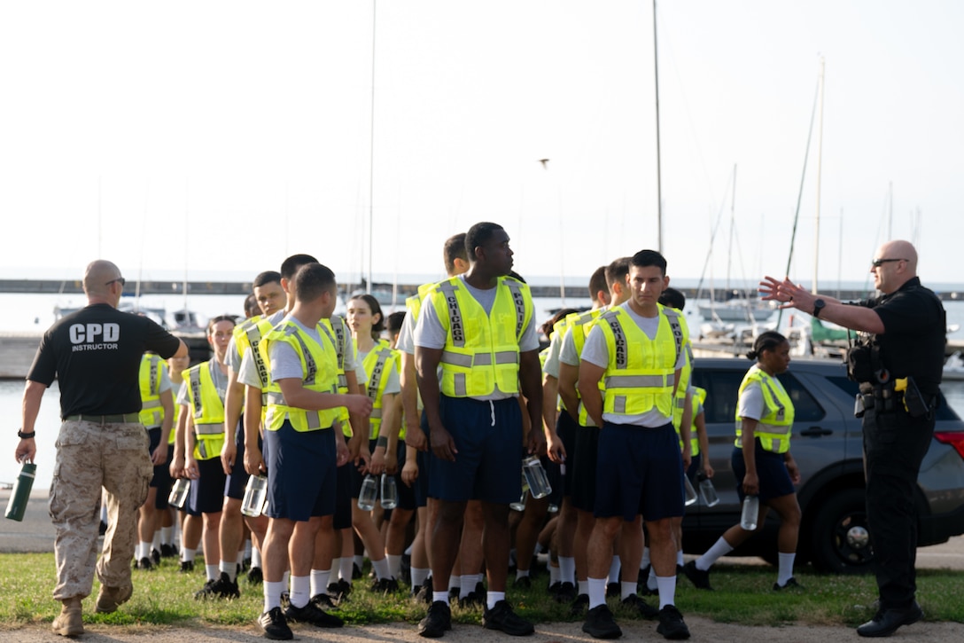 Chicago Police Department recruits at DuSable Harbor prepare for a physical training session with Marines assigned to Special Purpose Marine Air-Ground Task Force-250 during Marine Week Chicago, July 10, 2025. Throughout 2025, Marines across the globe will celebrate the 250th birthday of the Corps, commemorating service, sacrifice, and priding themselves on living ‘Semper Fidelis’ or ‘Always Faithful’ to their nation and to each other. (U.S. Marine Corps photo by Lance Cpl. Andra Marton-Salgado)