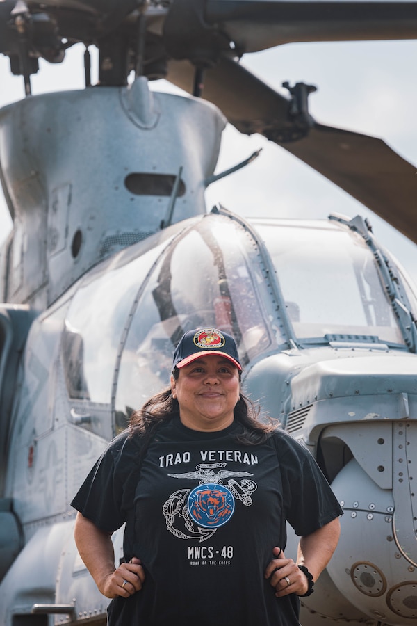 A Marine veteran poses for a picture at Romeoville High School during Marine Week Chicago, Illinois, July 10, 2025. During Marine Week Chicago, Marines with Marine Corps Recruiting Command shared Marine Corps traditions with local high schools in honor of the Corps’ 250th birthday. The Marine Corps is celebrating its 250th birthday with six multi-day Marine Corps community events, called Marine Weeks, in six major cities across the country. Marine Weeks will include activations across each host city featuring aircraft, equipment, recruiting opportunities, and public engagements. (U.S. Marine Corps photo by Cpl. Sarah Grawcock)