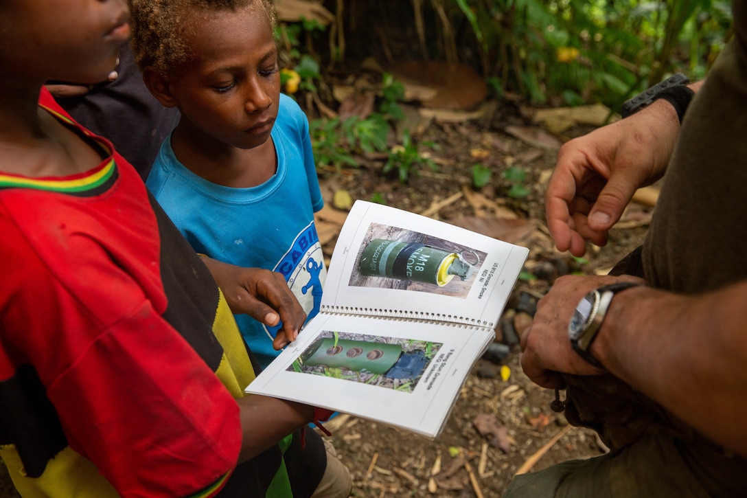 U.S. Marine Staff Sgt. Jeremiah Rogers, an explosive ordnance disposal technician, with Marine Rotational Force Darwin – 25.3, informs the local youth about the dangers of ordnance in the Rabaul region of Papua New Guinea, on June 10, 2025.