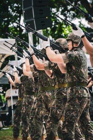 Republic of Korea soldiers stand with their weapons as they prepare to fire during the 75th anniversary Commemoration of the Battle of Cheonan, Cheonan City, South Korea, July 8, 2025.