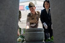 U.S. Army Col. Kristin Steinbrecher, incoming U.S. Army Garrison Humphreys garrison commander, and Kim Haeng-geum, chairperson of the Cheonan City Council, offer flowers during the 75th anniversary Commemoration of the Battle of Cheonan, Cheonan City, South Korea, July 8, 2025.