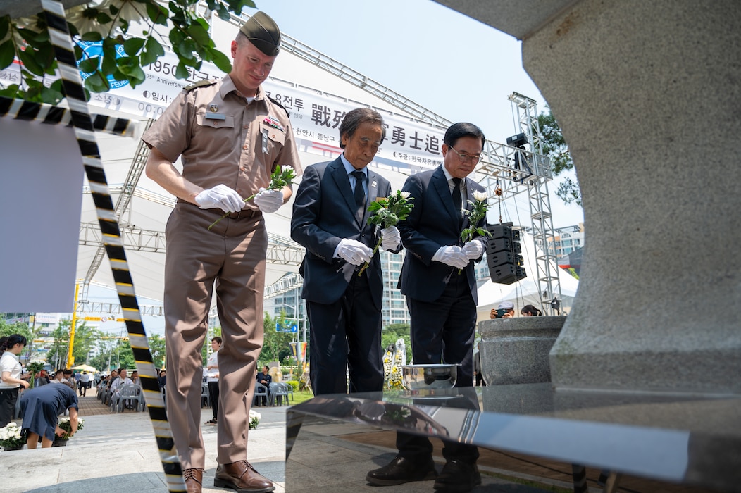 From left: U.S. Army Col. Ryan Workman, U.S. Army Garrison Humphreys garrison commander, Jang Gyu-yong, Korea Freedom Federation Cheonan Branch president, and Kang Seok-ho, president of Korea Freedom Federation, carry flowers to offer during the 75th anniversary Commemoration of the Battle of Cheonan, Cheonan City, South Korea, July 8, 2025.