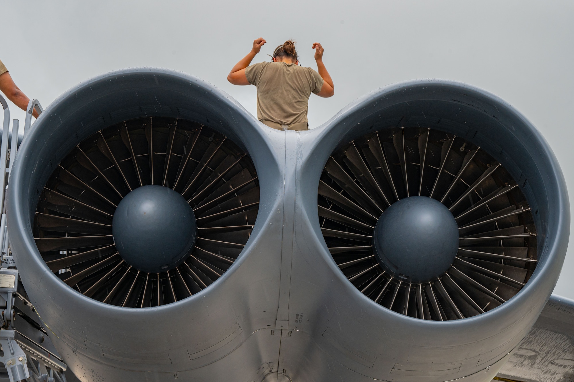 U.S. Air Force Senior Airman Bethany Jones, 23rd Expeditionary Bomber Generation Squadron assistant dedicated crew chief, performs post-flight maintenance on a USAF B-52H Stratofortress after a Bomber Task Force mission at Andersen Air Force Base, Guam, July 7, 2025. The U.S. demonstrates commitment to allies and partners, including those in the Indo-Pacific, through the global employment of military forces, such as regular BTF deployments. (U.S. Air Force photo by Airman 1st Class Vincent Padilla)