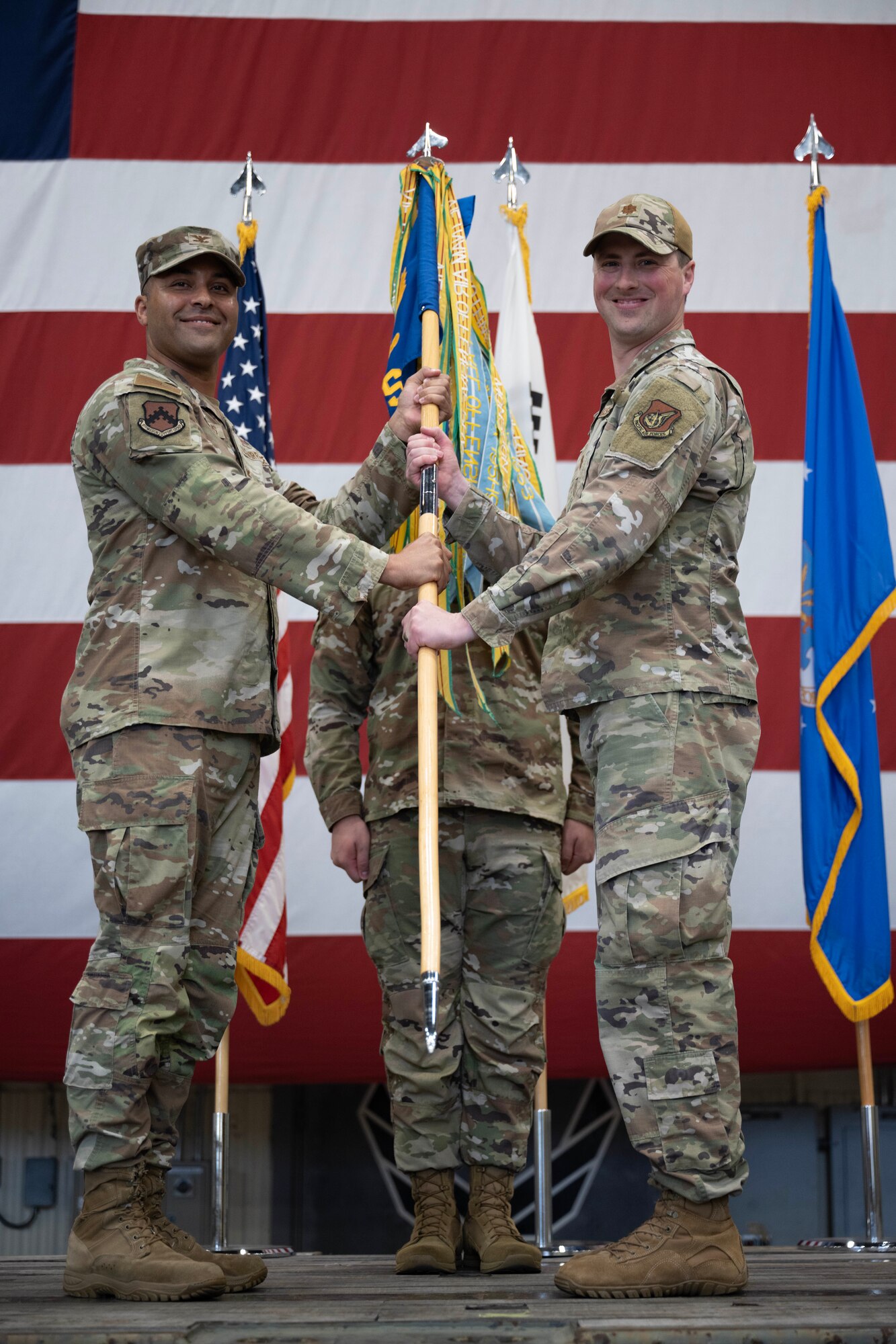 U.S. Air Force Joshua Hawkins, 8th Mission Support Group commander, passes command to Maj. Stephen Perkins, 8th Communications Squadron incoming commander