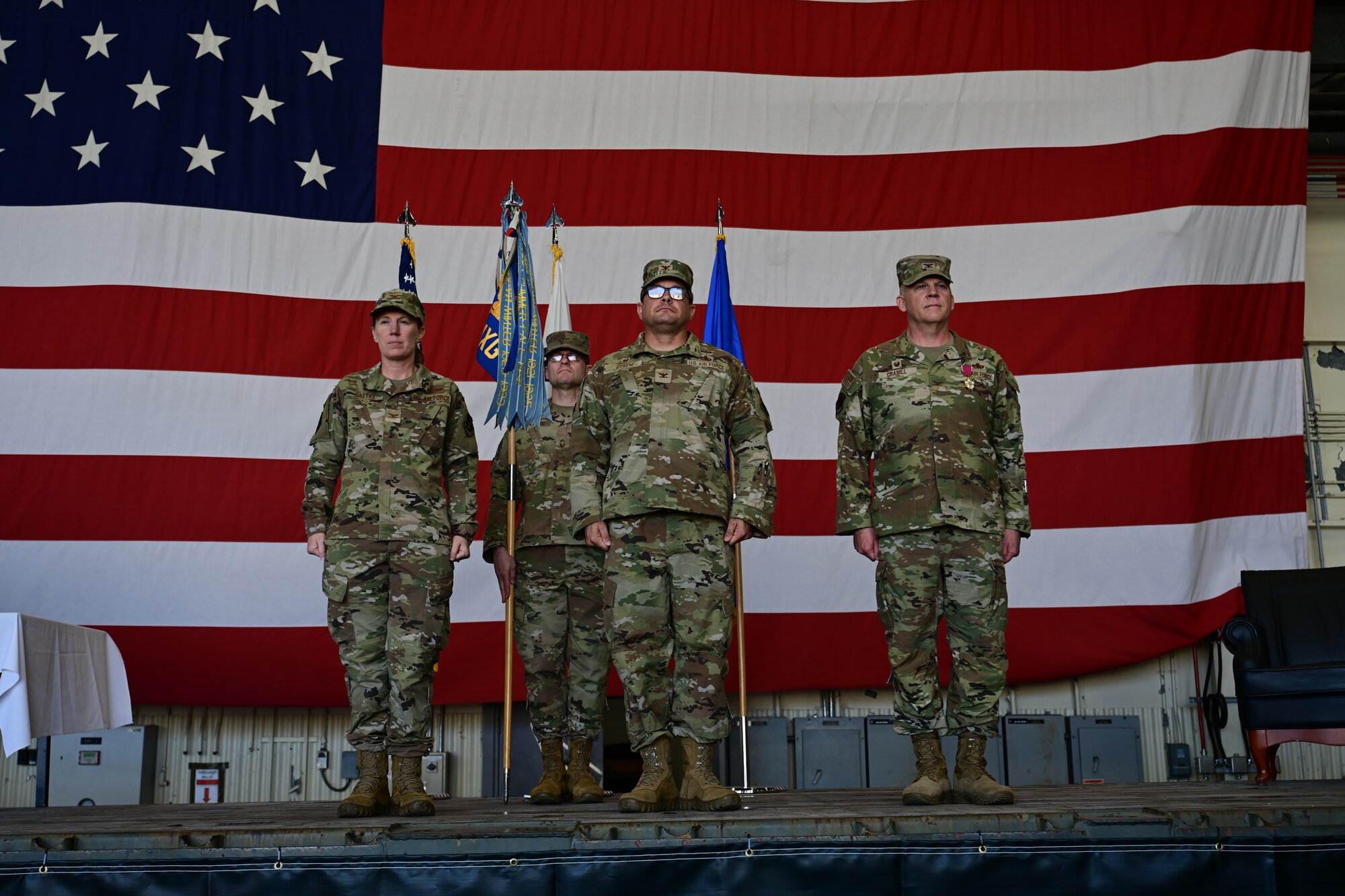 U.S. Air Forces Col. Kathryn Gaetke, 8th Fighter Wing commander, Chief Master Sgt. Nathan Bouchard, 8th Maintenance Group senior enlisted leader, Col. Blair Byrem, 8th MXG incoming commander, and Col. Casey Crabill, outgoing 8th MXG commander, stand during a change command ceremony