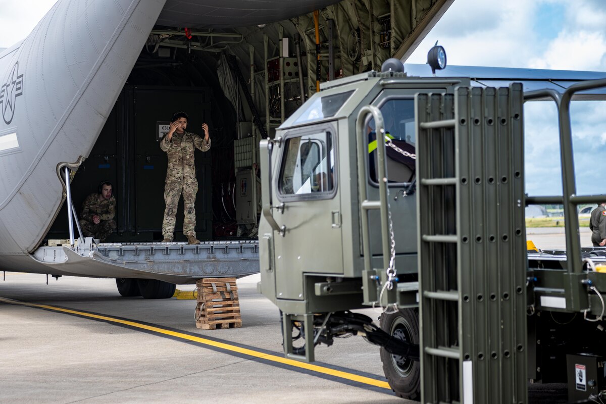 U.S. Air Force Staff Sgt. Adam Tristram, 36th Airlift Squadron air transportation cargo unloader, directs a K-loader truck towards a U.S. Air Force C-130J Super Hercules for cargo offloading in support of exercise Resolute Force Pacific (REFORPAC) 2025 at Misawa Air Base, Japan, July 10, 2025.