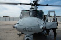 U.S. Marines with Marine Light Attack Helicopter Squadron (HMLA) 773, 4th Marine Aircraft Wing, assigned to Special Marine Air-Ground Task Force-250 conduct pre-flight checks on a UH-1Y Venom helicopter for an outreach and engagement flight during Marine Week Chicago, July 11, 2025. This year, the Marine Corps will celebrate two and a half centuries of serving the Nation with honor, courage, and commitment. (U.S. Marine Corps photo by Cpl. Diana Salgado)