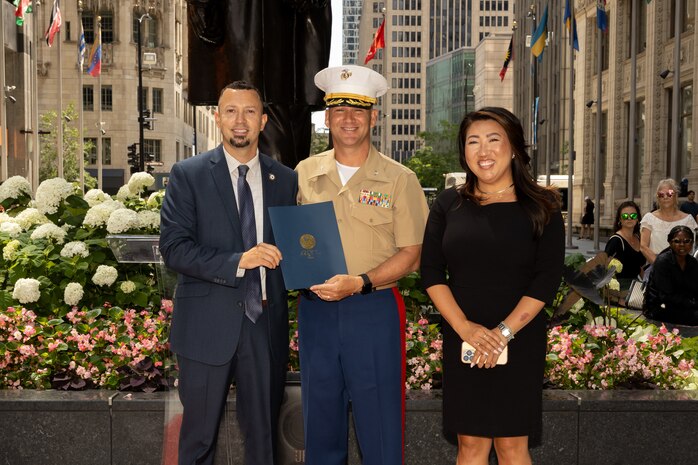 Kevin Barszcz, the director of Veterans Affairs for Chicago, left, U.S Marine Corps Col. J.J. Wilson, the commanding officer of Special Purpose Marine Air-Ground Task Force-250, center, and Tracey Campbell, the director of community relations for the U.S. Marine Corps, pose for a photo during Marine Week Chicago, July 10, 2025. The opening ceremony signifies the start of the event and presents the ethos of U.S. Marines to Chicago residents. Throughout 2025, Marines across the globe will celebrate the 250th birthday of the Corps, commemorating service, sacrifice, and priding themselves on living ‘Semper Fidelis’ or ‘Always Faithful’ to their nation and to each other. (U.S. Marine Corps photo by Lance Cpl. Elijua Guel)