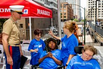 U.S Marine Corps Capt. James Mercure, the deputy Communication Strategy and Operations Officer of Marine Week Chicago, speaks with Make-A-Wish children and their families during Marine Week Chicago, July 10, 2025. The opening ceremony signifies the start of the event and represents the ethos of U.S. Marines to city residents. Throughout 2025, Marines across the globe will celebrate the 250th birthday of the Corps, commemorating service, sacrifice, and priding themselves on living ‘Semper Fidelis’ or ‘Always Faithful’ to their nation and to each other. (U.S. Marine Corps photo by Lance Cpl. Elijua Guel)