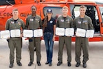 Secretary Kristi Noem presents medals to Lieutenant Ian Hopper, Lieutenant Blair Oguiofor, Petty Officer 3rd Class Scott Ruskan, and Petty Officer 3rd Class Seth Reece of Air Station Corpus Christi during a ceremony on July 11, 2025. The medals recognize their roles in the Camp Mystic rescue on July 4, when Coast Guard crews evacuated dozens of campers and staff amid flash flooding at the Guadalupe River.