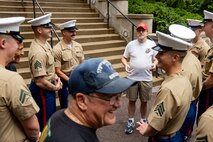 U.S. Marines assigned to Special Purpose Marine Air-Ground Task Force-250 and retired servicemembers talk before a wreath laying ceremony at the Vietnam Veterans Memorial during Marine Week Chicago, July 11, 2025. The wreath laying ceremony was held to honor U.S. Marine Corps Sgt. Thomas Gilbert and other Marines who paid the ultimate sacrifice during Operation Iraqi Freedom. This year, the Marine Corps will celebrate two and a half centuries of serving the nation with honor, courage, and commitment. (U.S. Marine Corps photo by Lance Cpl. Elijua Guel)