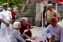 U.S. Marine Corps Col. J.J. Wilson, the commanding officer of Special Purpose Marine Air-Ground Task Force-250, interacts with families prior to a wreath laying ceremony at the Vietnam Veterans Memorial during Marine Week Chicago, July 11, 2025. The wreath laying ceremony was held to honor U.S. Marine Corps Sgt. Thomas Gilbert and other Marines who paid the ultimate sacrifice during Operation Iraqi Freedom. This year, the Marine Corps will celebrate two and a half centuries of serving the nation with honor, courage, and commitment. (U.S. Marine Corps photo by Lance Cpl. Elijua Guel)