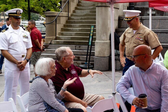 U.S. Marine Corps Col. J.J. Wilson, the commanding officer of Special Purpose Marine Air-Ground Task Force-250, interacts with families prior to a wreath laying ceremony at the Vietnam Veterans Memorial during Marine Week Chicago, July 11, 2025. The wreath laying ceremony was held to honor U.S. Marine Corps Sgt. Thomas Gilbert and other Marines who paid the ultimate sacrifice during Operation Iraqi Freedom. This year, the Marine Corps will celebrate two and a half centuries of serving the nation with honor, courage, and commitment. (U.S. Marine Corps photo by Lance Cpl. Elijua Guel)