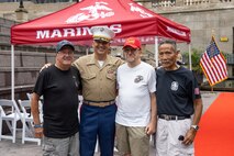 U.S. Marine Corps Col. J.J. Wilson, the commanding officer of Special Purpose Marine Air-Ground Task Force-250, and retired servicemembers pose for a photo prior to a wreath laying ceremony at the Vietnam Veterans Memorial during Marine Week Chicago, July 11, 2025. The wreath laying ceremony was held to honor U.S. Marine Corps Sgt. Thomas Gilbert and other Marines who paid the ultimate sacrifice during Operation Iraqi Freedom. This year, the Marine Corps will celebrate two and a half centuries of serving the nation with honor, courage, and commitment. (U.S. Marine Corps photo by Lance Cpl. Elijua Guel)