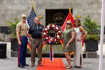 U.S. Marine Corps Col. J.J. Wilson, the commanding officer of Special Purpose Marine Air-Ground Task Force-250, left, Mike Gilbert, father of U.S. Marine Corps Sgt. Thomas Gilbert, second from the left, and family members of Gilbert pose for a photo after a wreath laying ceremony at the Vietnam Veterans Memorial during Marine Week Chicago, July 11, 2025. The wreath laying ceremony was held to honor U.S. Marine Corps Sgt. Thomas Gilbert and other Marines who paid the ultimate sacrifice during Operation Iraqi Freedom. This year, the Marine Corps will celebrate two and a half centuries of serving the nation with honor, courage, and commitment. (U.S. Marine Corps photo by Lance Cpl. Elijua Guel)