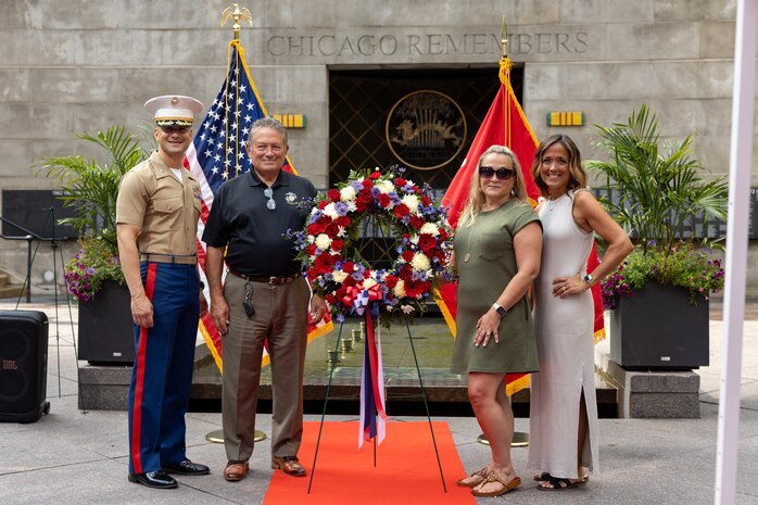 U.S. Marine Corps Col. J.J. Wilson, the commanding officer of Special Purpose Marine Air-Ground Task Force-250, left, Mike Gilbert, father of U.S. Marine Corps Sgt. Thomas Gilbert, second from the left, and family members of Gilbert pose for a photo after a wreath laying ceremony at the Vietnam Veterans Memorial during Marine Week Chicago, July 11, 2025. The wreath laying ceremony was held to honor U.S. Marine Corps Sgt. Thomas Gilbert and other Marines who paid the ultimate sacrifice during Operation Iraqi Freedom. This year, the Marine Corps will celebrate two and a half centuries of serving the nation with honor, courage, and commitment. (U.S. Marine Corps photo by Lance Cpl. Elijua Guel)