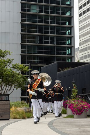 The Quantico Marine Band, assigned to Special Purpose Marine Air-Ground Task Force-250, march toward a ceremony for Jamaria Peters at the Willis Tower during Marine Week Chicago, July 11, 2025. The event featured a performance from the Marine Corps Silent Drill Platoon, music from the Quantico Marine Band, and the appearance of drill instructors from Marine Corps Recruit Depot San Diego. This year, the Marine Corps will celebrate two and a half centuries of serving the Nation with honor, courage, and commitment. (U.S. Marine Corps photo by Lance Cpl. Elijua Guel)
