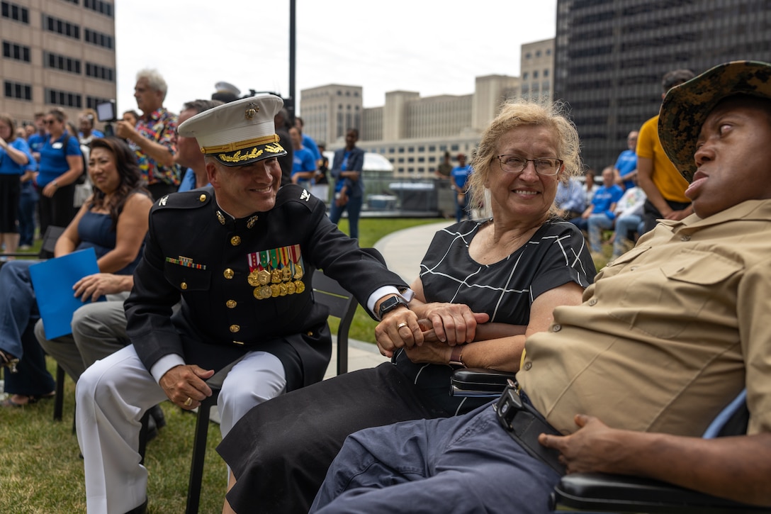 U.S. Marine Corps Col. J.J. Wilson, the commanding officer of Special Purpose Marine Air-Ground Task Force-250, and Jamaria Peters, a Make-A-Wish recipient, shake hands during a ceremony for Jamaria Peters at the Willis Tower during Marine Week Chicago, July 11, 2025. The event featured a performance from the Marine Corps Silent Drill Platoon, music from the Quantico Marine Band, and the appearance of drill instructors from Marine Corps Recruit Depot San Diego. This year, the Marine Corps will celebrate two and a half centuries of serving the nation with honor, courage, and commitment. (U.S. Marine Corps photo by Lance Cpl. Elijua Guel)