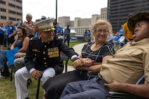U.S. Marine Corps Col. J.J. Wilson, the commanding officer of Special Purpose Marine Air-Ground Task Force-250, and Jamaria Peters, a Make-A-Wish recipient, shake hands during a ceremony for Jamaria Peters at the Willis Tower during Marine Week Chicago, July 11, 2025. The event featured a performance from the Marine Corps Silent Drill Platoon, music from the Quantico Marine Band, and the appearance of drill instructors from Marine Corps Recruit Depot San Diego. This year, the Marine Corps will celebrate two and a half centuries of serving the nation with honor, courage, and commitment. (U.S. Marine Corps photo by Lance Cpl. Elijua Guel)