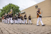U.S. Marine Corps Band Quantico performs at Romeoville High School during Marine Week Chicago, July 10, 2025. During Marine Week Chicago, Marines with Marine Corps Recruiting Command shared Marine Corps traditions with local high schools in honor of the Corps’ 250th birthday. The Marine Corps is celebrating its 250th birthday with six multi-day Marine Corps community events, called Marine Weeks, in six major cities across the country. Marine Weeks will include activations across each host city featuring aircraft, equipment, recruiting opportunities, and public engagements. (U.S. Marine Corps photo by Staff Sgt. Brandon Salas)