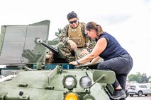An attendee gets a tour of a Light Armored Vehicle at Romeoville High School during Marine Week Chicago, Illinois, July 10, 2025. During Marine Week Chicago, Marines with Marine Corps Recruiting Command shared Marine Corps traditions with local high schools in honor of the Corps’ 250th birthday. The Marine Corps is celebrating its 250th birthday with six multi-day Marine Corps community events, called Marine Weeks, in six major cities across the country. Marine Weeks will include activations across each host city featuring aircraft, equipment, recruiting opportunities, and public engagements. (U.S. Marine Corps photo by Staff Sgt. Brandon Salas)