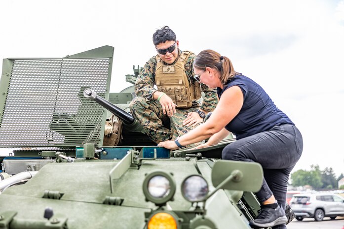 An attendee gets a tour of a Light Armored Vehicle at Romeoville High School during Marine Week Chicago, Illinois, July 10, 2025. During Marine Week Chicago, Marines with Marine Corps Recruiting Command shared Marine Corps traditions with local high schools in honor of the Corps’ 250th birthday. The Marine Corps is celebrating its 250th birthday with six multi-day Marine Corps community events, called Marine Weeks, in six major cities across the country. Marine Weeks will include activations across each host city featuring aircraft, equipment, recruiting opportunities, and public engagements. (U.S. Marine Corps photo by Staff Sgt. Brandon Salas)