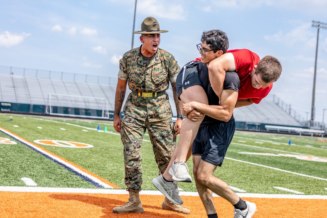 U.S. Marine Corps Sgt. Rasheed Awyan, a drill instructor with Marine Corps Recruit Depot San Diego, 2nd Recruit Training Battalion, motivates a poolee during a combat fitness test at Romeoville High School during Marine Week Chicago, July 10, 2025. During Marine Week Chicago, Marines with Marine Corps Recruiting Command shared Marine Corps traditions with local high schools in honor of the Corps’ 250th birthday. The Marine Corps is celebrating its 250th birthday with six multi-day Marine Corps community events, called Marine Weeks, in six major cities across the country. Marine Weeks will include activations across each host city featuring aircraft, equipment, recruiting opportunities, and public engagements. (U.S. Marine Corps Staff Sgt. Brandon Salas)