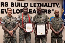 From left, U.S. Marine Corps First Sgt. Daniel Gonzalez, Cpl. Javontay Vickers, Master Gunnery Sgt. Louis Vickers and First Sgt. Marcus Kibble pose together after their promotion ceremony at the U.S. Army Sergeants Major Academy, Fort Bliss, Texas, June 9, 2025. Master Gunnery Sgt. Vickers and Cpl Vickers, a father and son combination, were promoted together on the same day. (U.S. Marine Corps photo by Staff Sergeant Joshua Smith)