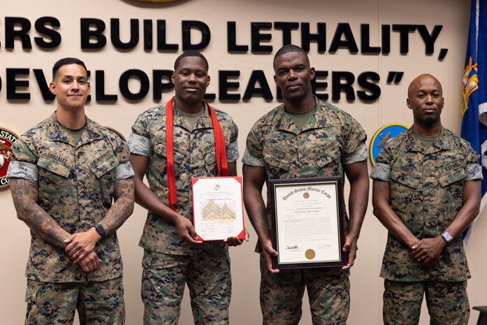 From left, U.S. Marine Corps First Sgt. Daniel Gonzalez, Cpl. Javontay Vickers, Master Gunnery Sgt. Louis Vickers and First Sgt. Marcus Kibble pose together after their promotion ceremony at the U.S. Army Sergeants Major Academy, Fort Bliss, Texas, June 9, 2025. Master Gunnery Sgt. Vickers and Cpl Vickers, a father and son combination, were promoted together on the same day. (U.S. Marine Corps photo by Staff Sergeant Joshua Smith)