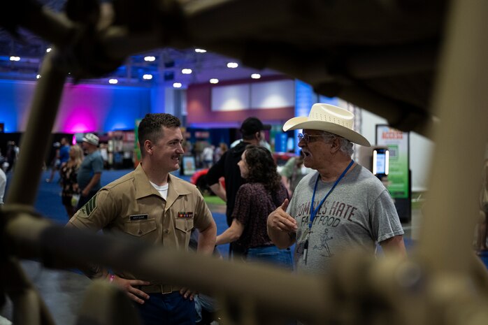 U.S. Marine Corps Sgt. Ethan Krysiak, a recruiter with Recruiting Sub-Station Murfreesboro, Recruiting Station Nashville, speaks to a man in the Music City Center in Nashville, Tennessee, June 5, 2025. Marines set up multiple equipment displays and recruiting booths during Marine Week to engage with the community. Throughout 2025, Marines across the globe will celebrate the 250th birthday of the Corps, commemorating, service, sacrifice, and priding themselves on living ‘Semper Fidelis’ or ‘Always Faithful’ to their nation and to each other. (U.S. Marine Corps photo by Cpl. Vincent Needham)